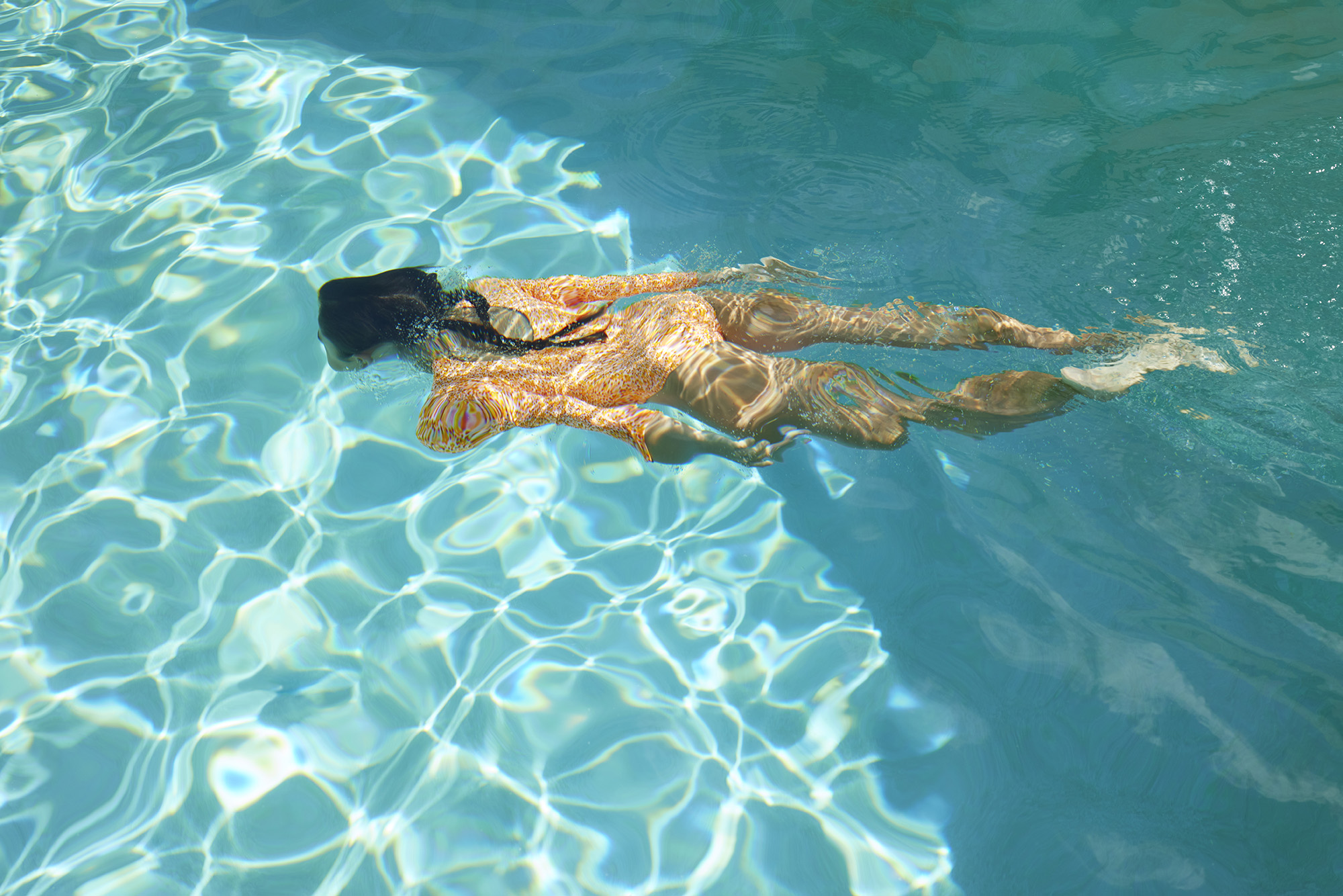 Woman swimming in pool amenity