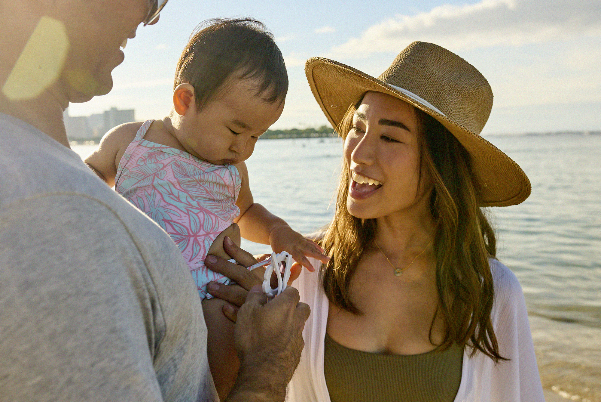 Happy couple with baby at the beach