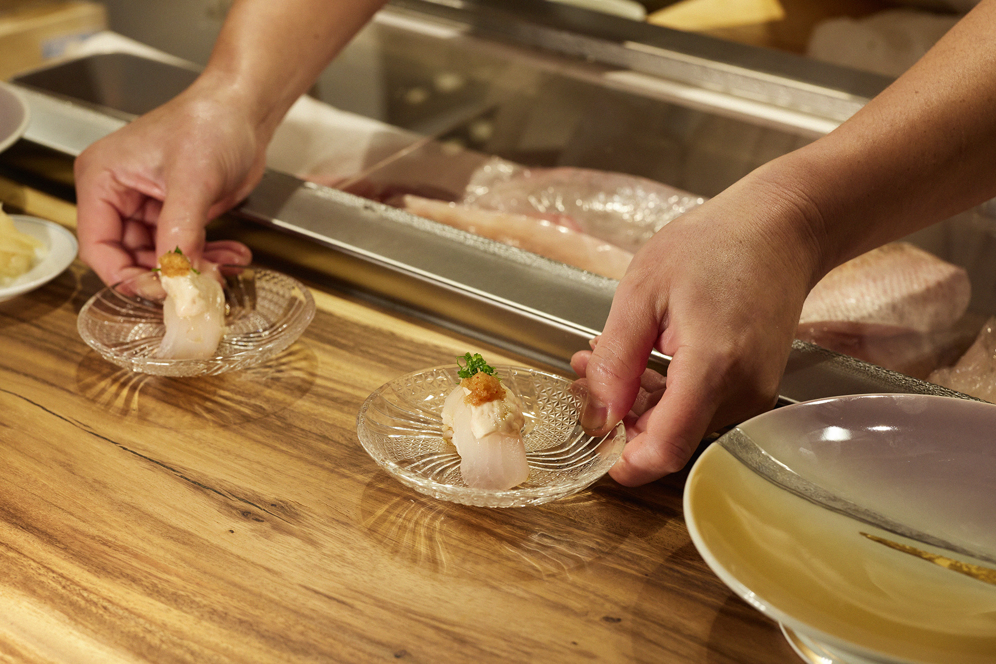 Person serving sushi