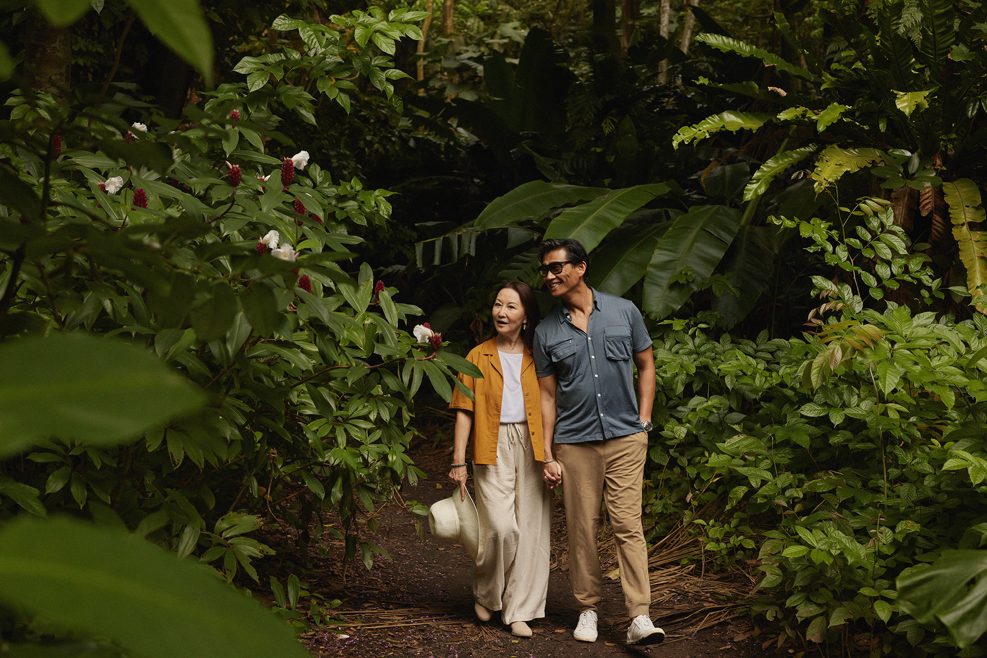 Couple walking along trail with lush landscaping