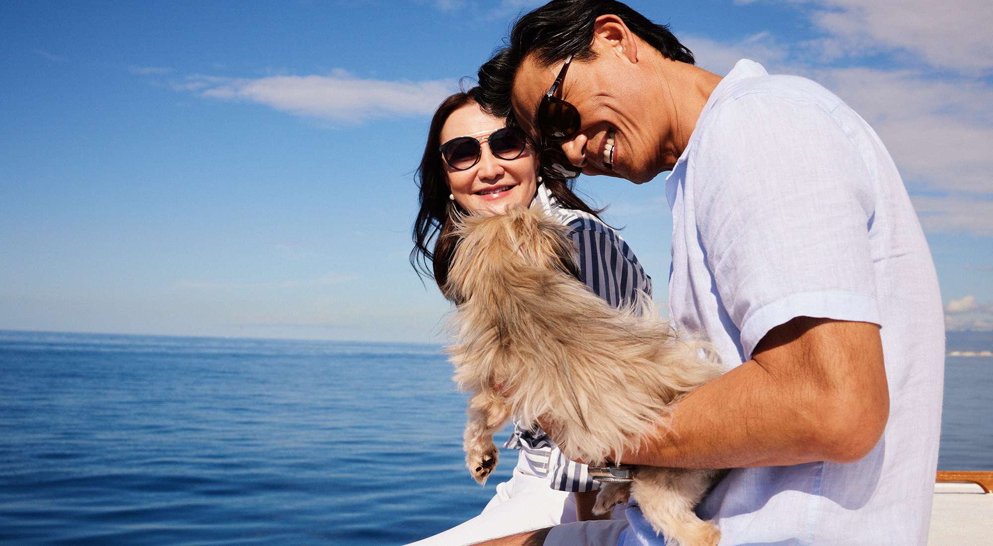 Couple on boat with small dog
